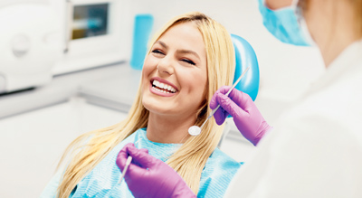 Woman smiling while in the dentist chair