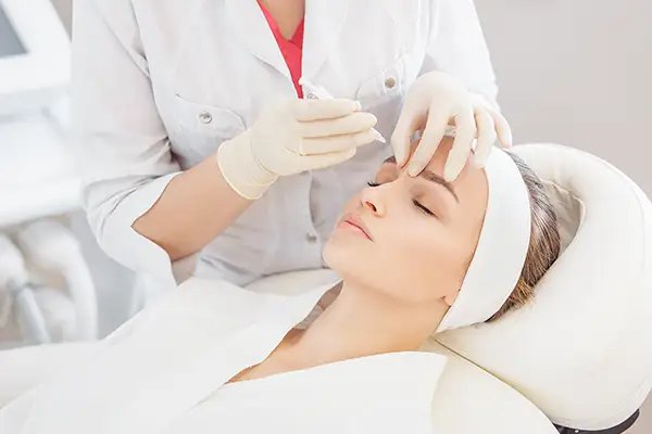 Woman receiving botox treatment on the bridge of her nose