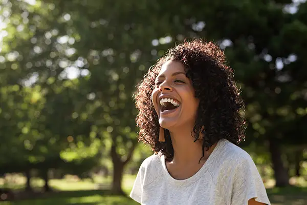 Woman laughing with mouth wide open